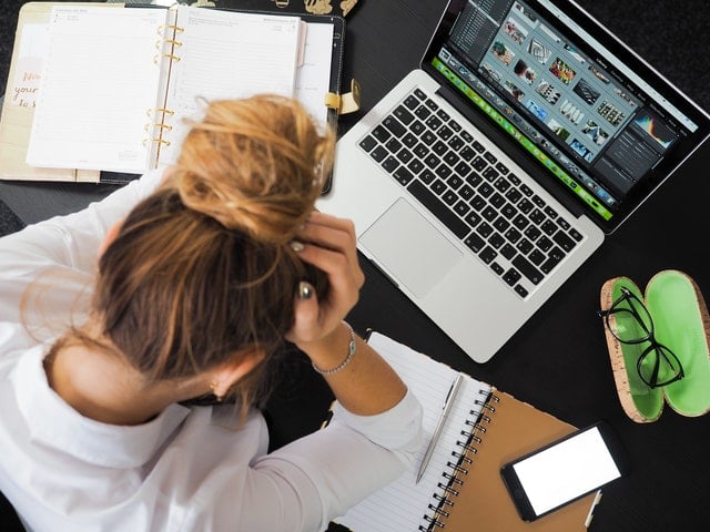 A woman frustrated at her laptop