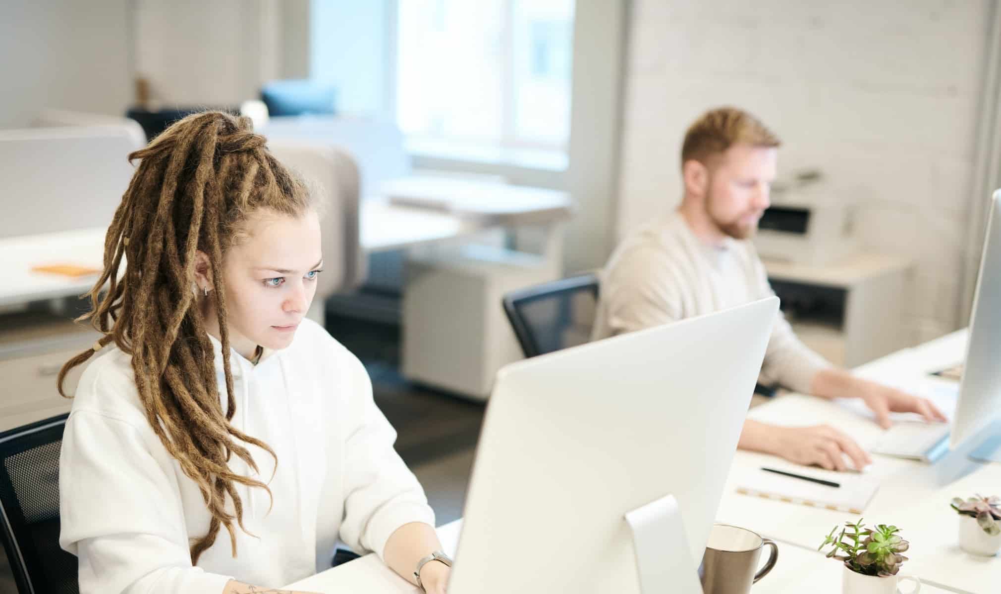 A woman and man at laptops