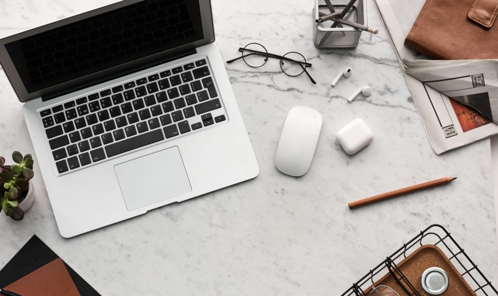 A laptop with glasses and a mouse