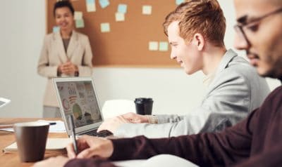 A man smiling at a computer